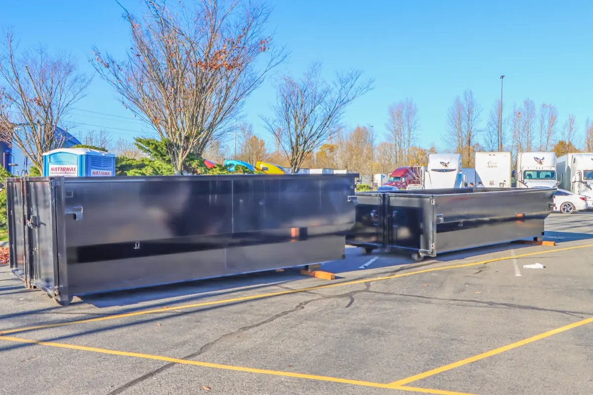 Professional dumpster rental service with roll-off container on residential driveway in Garrett